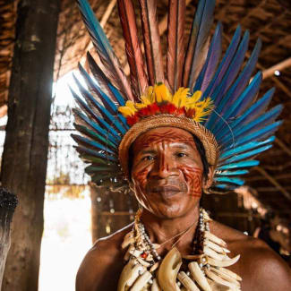 An indigenous man with traditional head cover