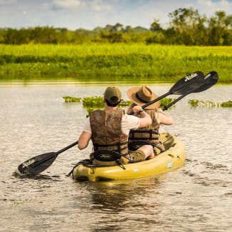 Two people kayaking the Amazon river
