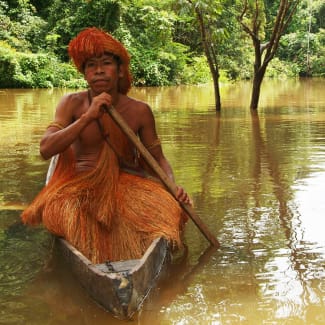Tribal man in a wooden boat