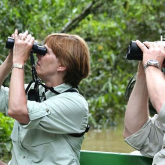 People bird watching through binoculars
