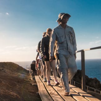 People walking on the wooden walkway